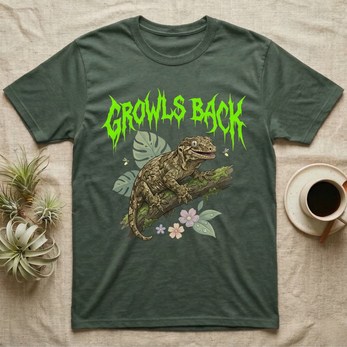Leachianus Gecko Feral T-Shirt in Military Green — Leachianus giant gecko on a mossy branch under jagged lime-green metal text GROWLS BACK with pastel leaves