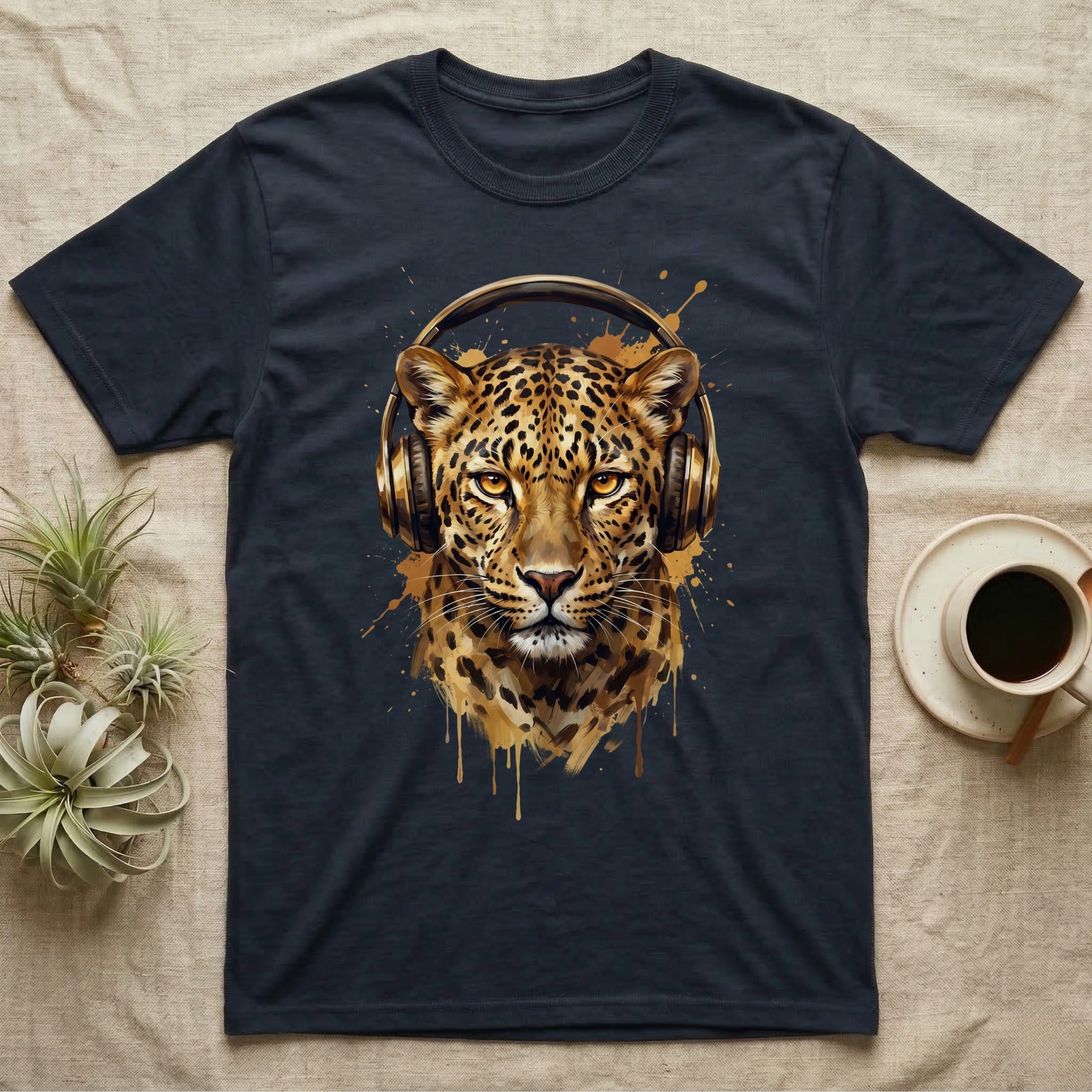 Leopard wearing gold headphones on a dark t-shirt.