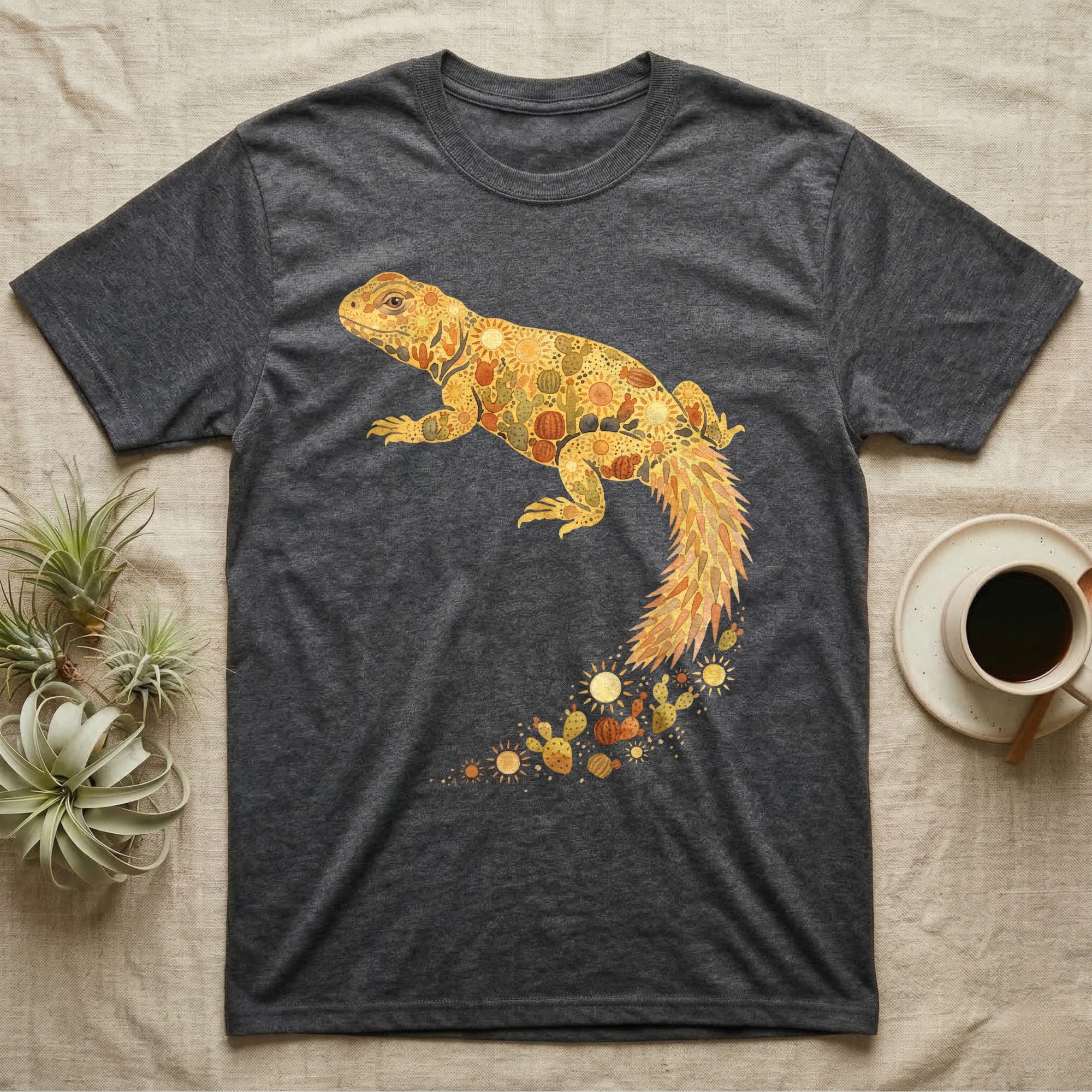 Uromastyx Solar Loaf T-Shirt in Dark Heather — Warm watercolour mosaic of a basking uromastyx lizard made of tiny suns, cacti and sand on grey