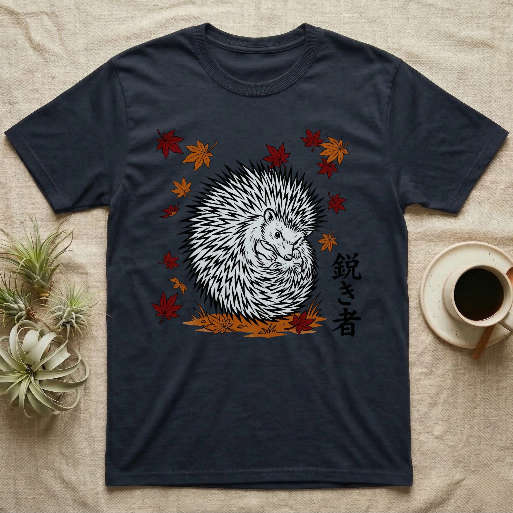 Dark t-shirt with a white hedgehog and Japanese text surrounded by autumn leaves.