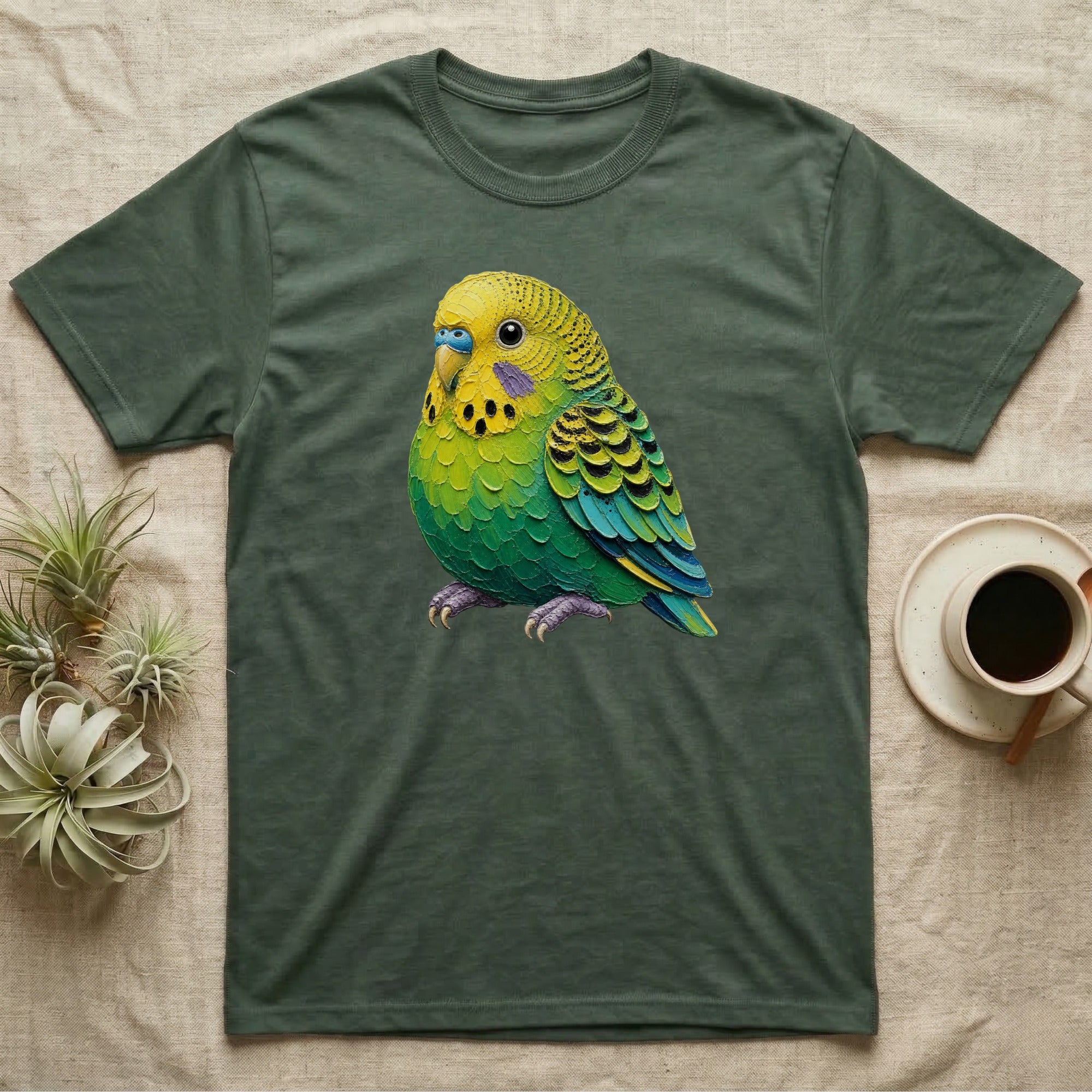 Green and yellow budgie bird graphic on a dark green t-shirt.