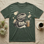 Cold Brew Bearded Dragon T-Shirt in Military Green — Flat near-photoreal illustration of a bearded dragon in tiny sunglasses holding a cold brew with warm bokeh.