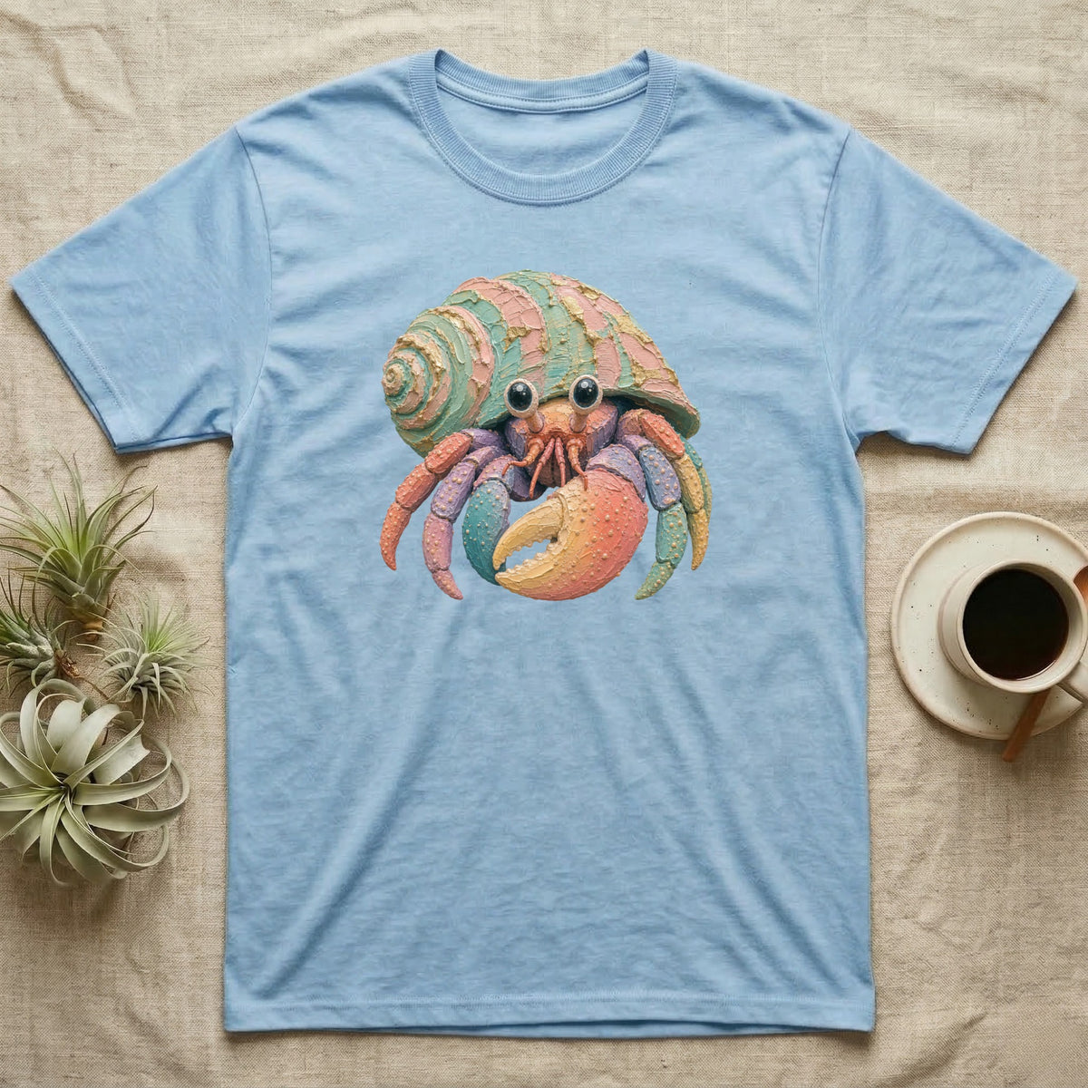 Light blue t-shirt featuring a colorful cartoon hermit crab.