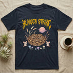 Ball Python Feral T-Shirt in Navy — Ball python coiled in a loaf in a pastel savanna scene under a spiky honey-gold metal wordmark reading HUNGER STRIKE.