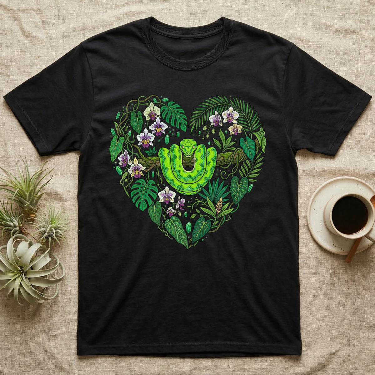 Black t-shirt with a green snake and tropical leaves forming a heart.