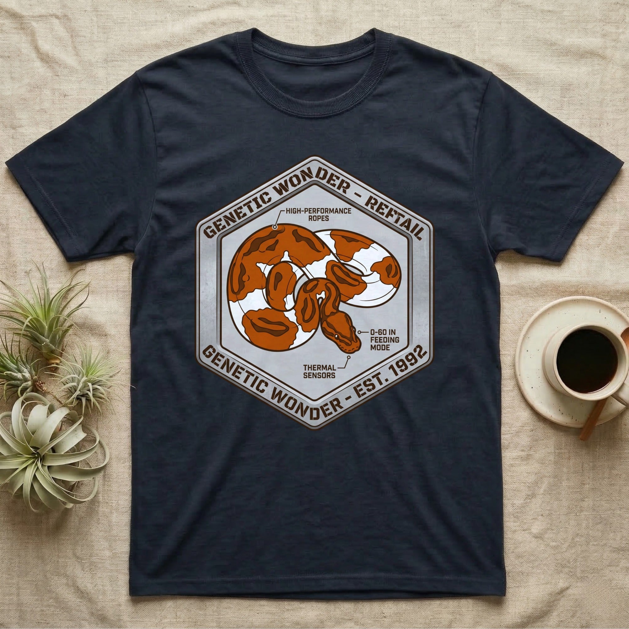 Dark t-shirt with hexagonal graphic of a snake, "Genetic Wonder - Reftail" and "Est. 1992".