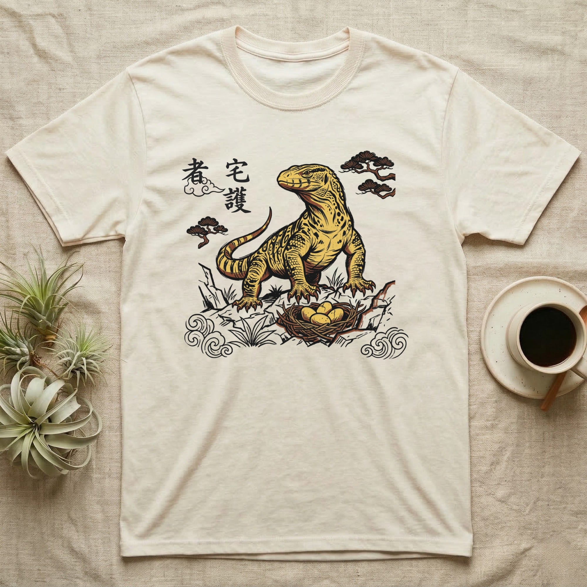 Cream t-shirt with yellow Komodo dragon and nest illustration with Japanese text.