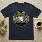 Panda King Isopod Trading Card T-Shirt in Navy — Metal stat-card badge showing a Panda King Cubaris isopod on limestone with HP and ability lines.