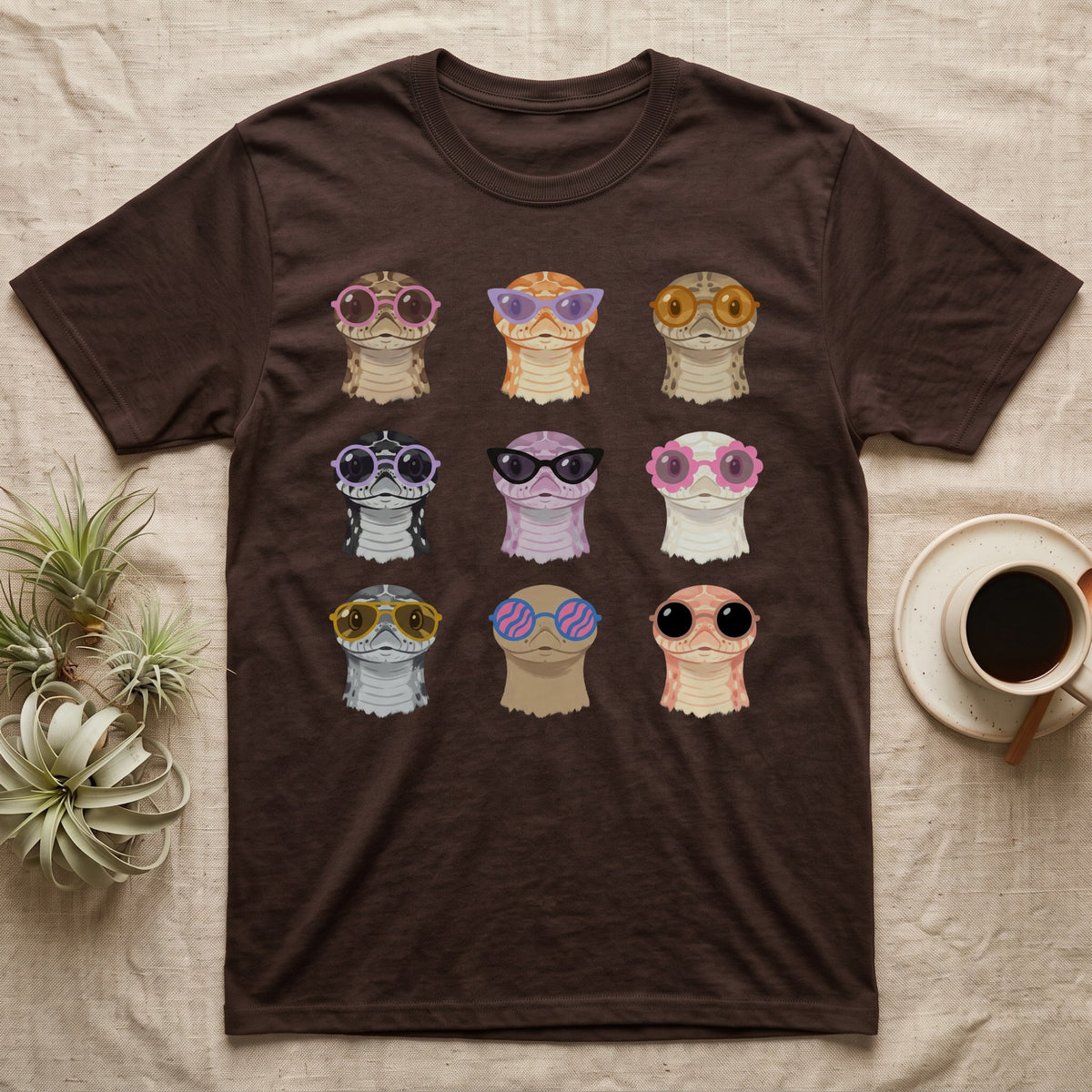 Hognose Morphs Sunglasses T-Shirt in Dark Chocolate — Gouache grid of nine western hognose snake morphs as frontal busts, each wearing different sunglasses