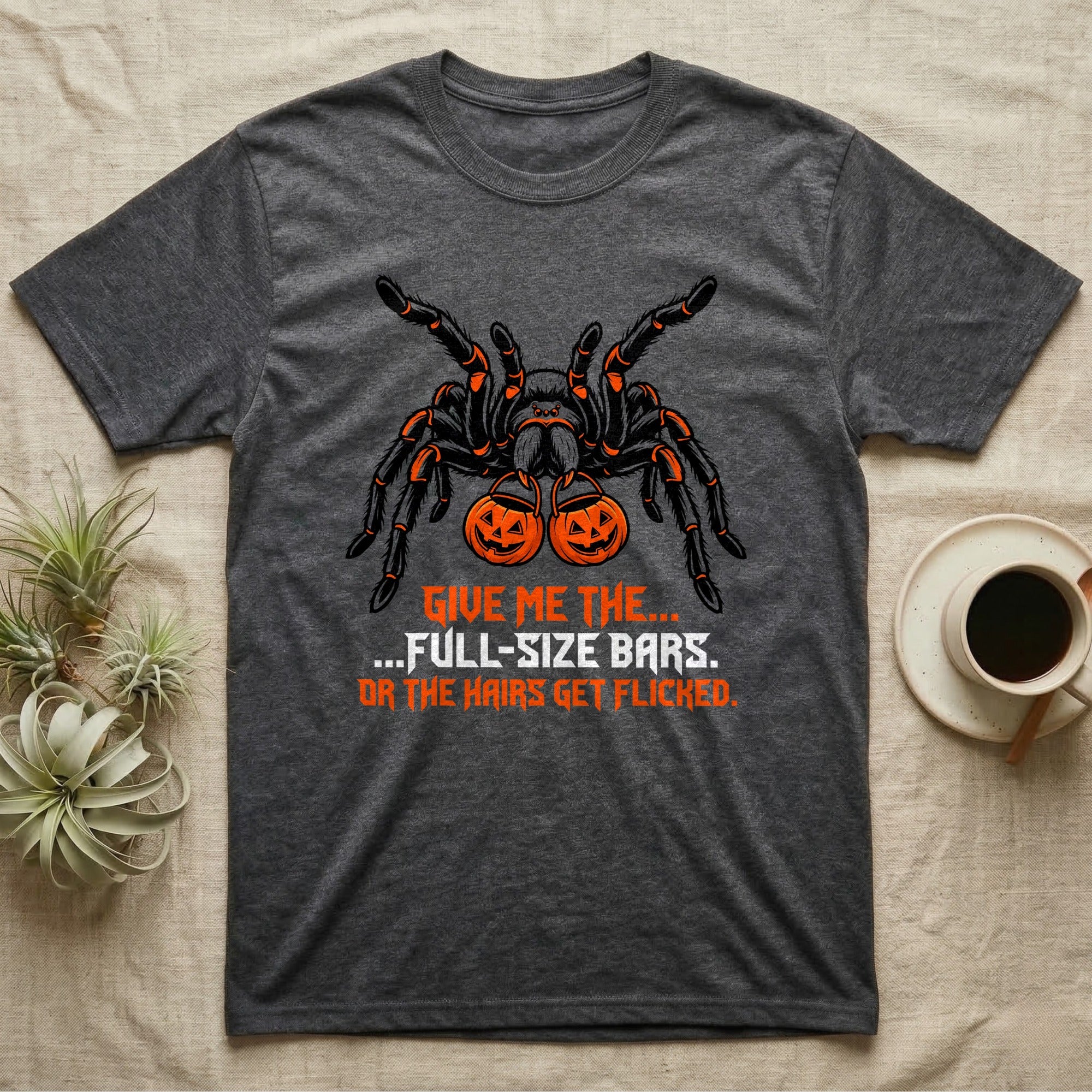 Tarantula Full-Size Bars T-Shirt in Dark Heather — Black-and-orange tarantula holding two jack-o'-lantern buckets, "Give Me the Full-Size Bars Or the Hairs Get Flicked."