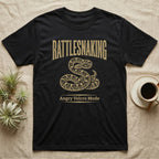 Corn Snake Rattlesnaking T-Shirt in Black — Distressed woodblock corn snake coiled with tail flicked out under an arched "Rattlesnaking" headline.