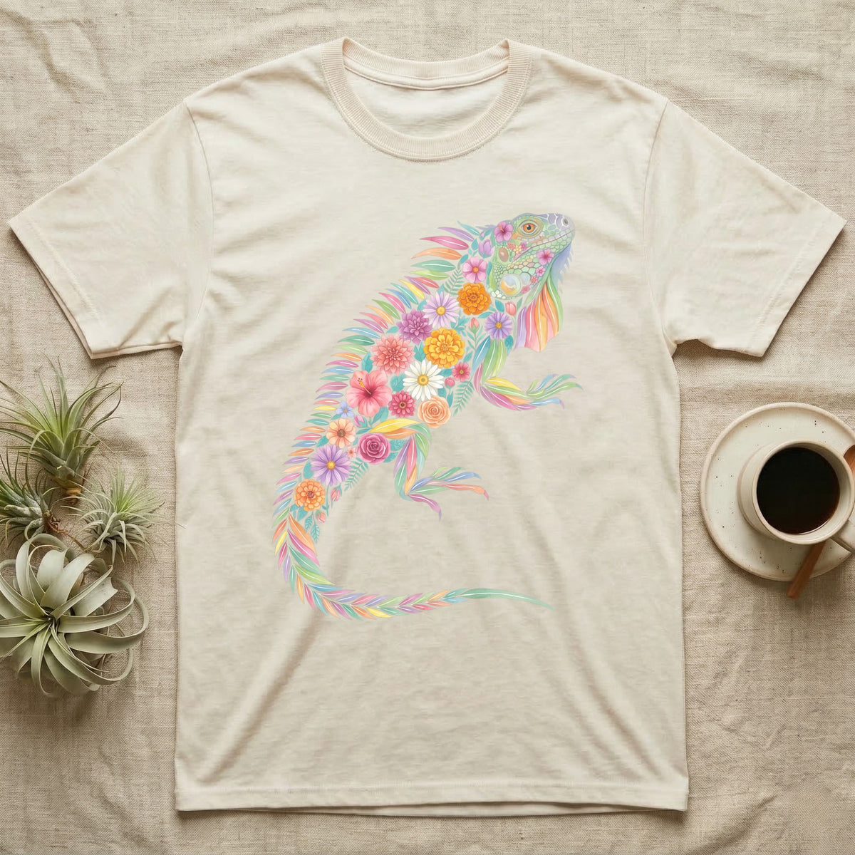 Green Iguana Floral Mosaic T-Shirt in Natural — Watercolour green iguana climbing, its whole body built from painted hibiscus, dandelion and leaf shapes.