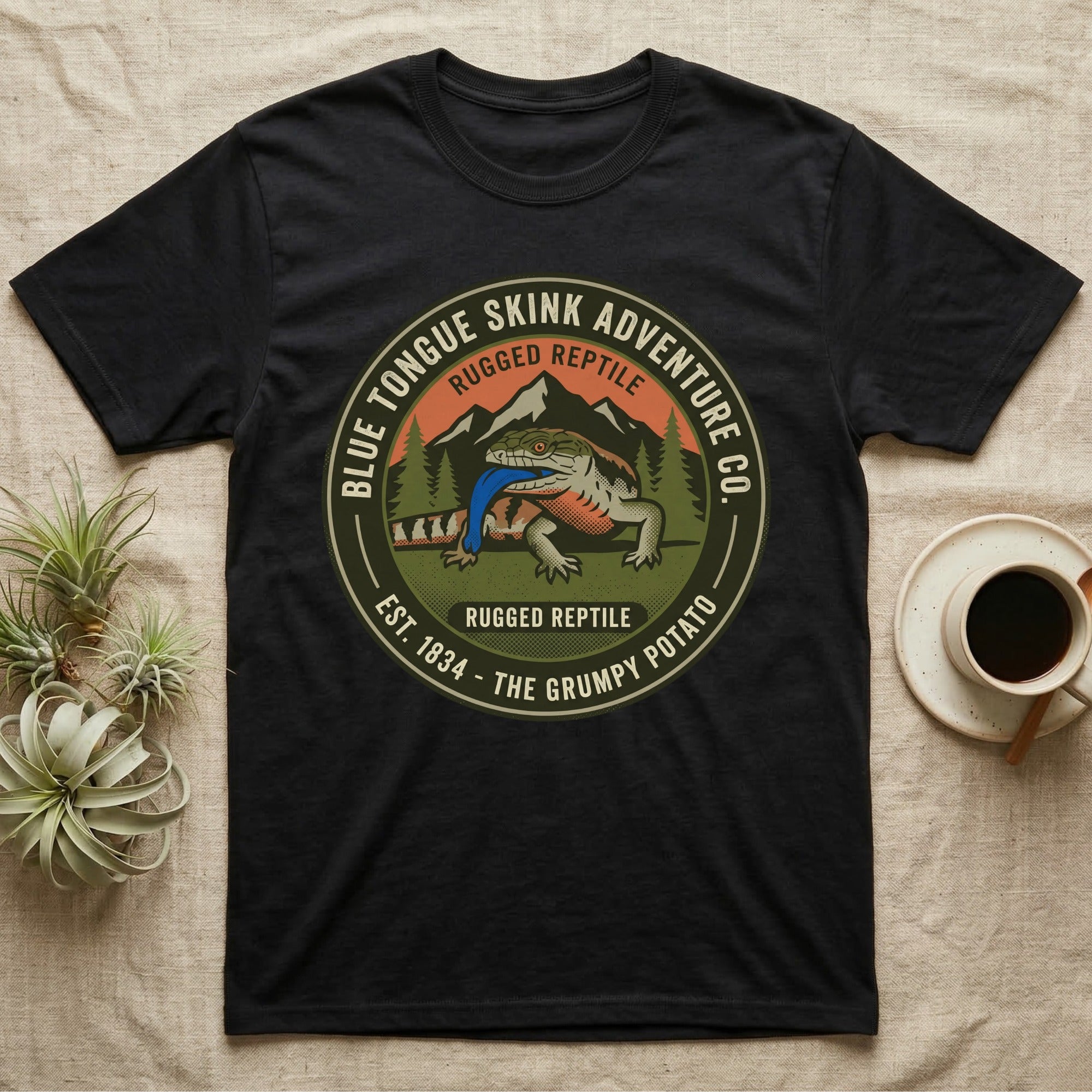 Black t-shirt with "Blue Tongue Skink Adventure Co." and a lizard graphic.