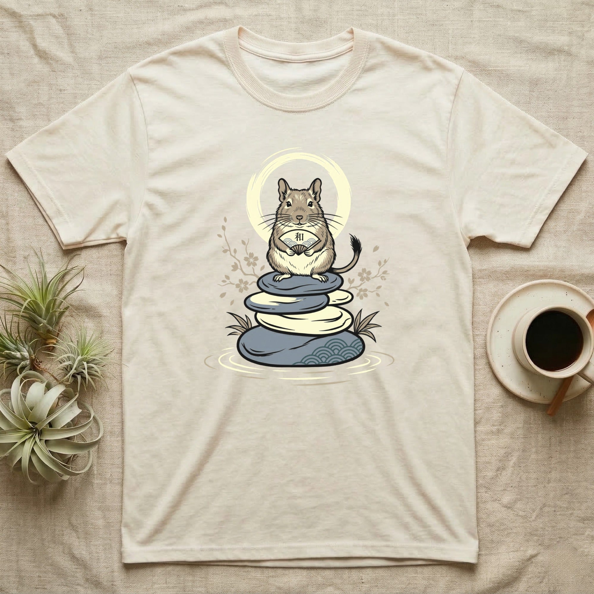 T-shirt with a chinchilla illustration sitting on stacked stones, holding a scroll.