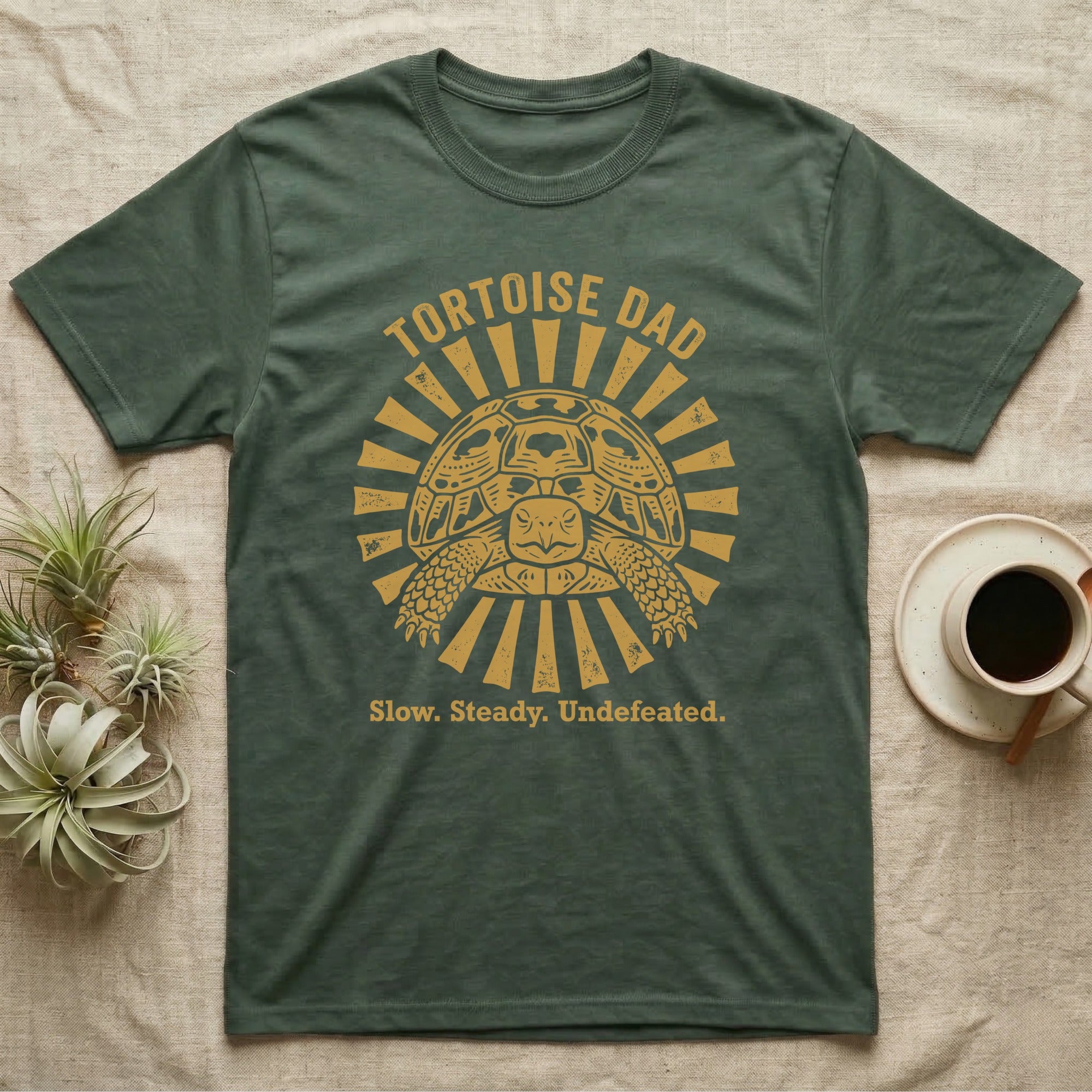 Hermann's Tortoise Dad T-Shirt in Military Green — Folk woodblock sunburst badge of a Hermann's tortoise with arched "Tortoise Dad" lettering in ochre ink.