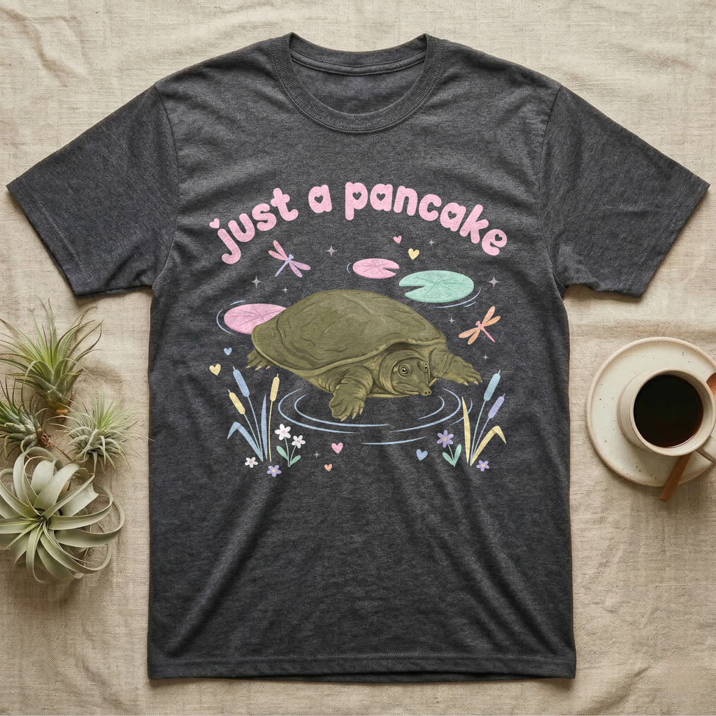 Spiny Softshell Turtle Baby T-Shirt in Dark Heather — Pastel spiny softshell turtle with flat shell and snorkel nose among lily pads, puffy pink wordmark "just a pancake" above.