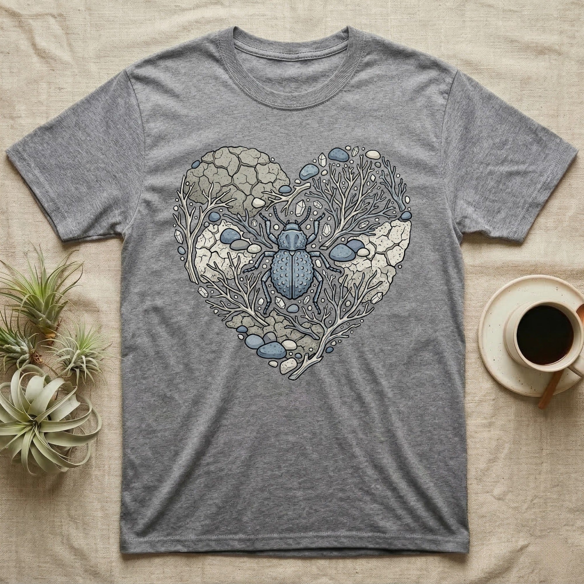 Grey t-shirt with a blue beetle and heart-shaped natural design.