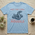 Hognose Snake Noodle T-Shirt in Light Blue — Navy engraving of a coiled western hognose snake bluffing with a flattened neck between the words PART-TIME COBRA and full-time NOODLE in rose