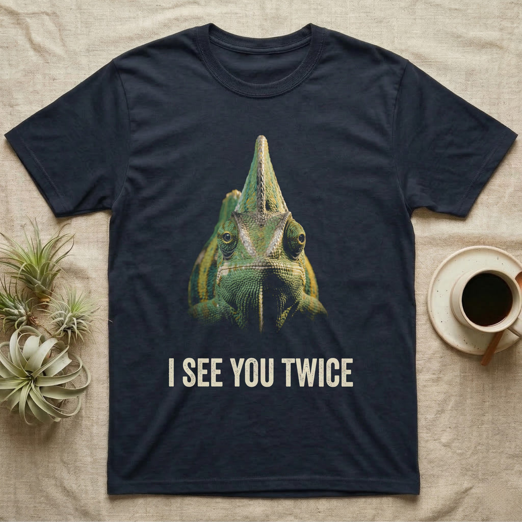 Deadpan photographic mugshot of a veiled chameleon facing the camera beneath its tall casque with the distressed text I See You Twice. — shown on a Navy tee.