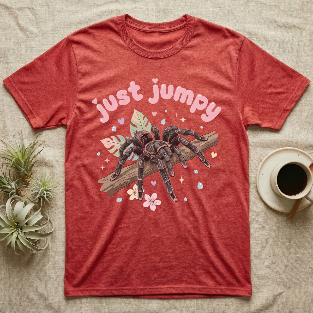 Pink Toe Tarantula Softie T-Shirt in Heather Red — Pink toe tarantula poised to leap on a branch under a puffy pastel "just jumpy" bubble wordmark with tiny hearts.