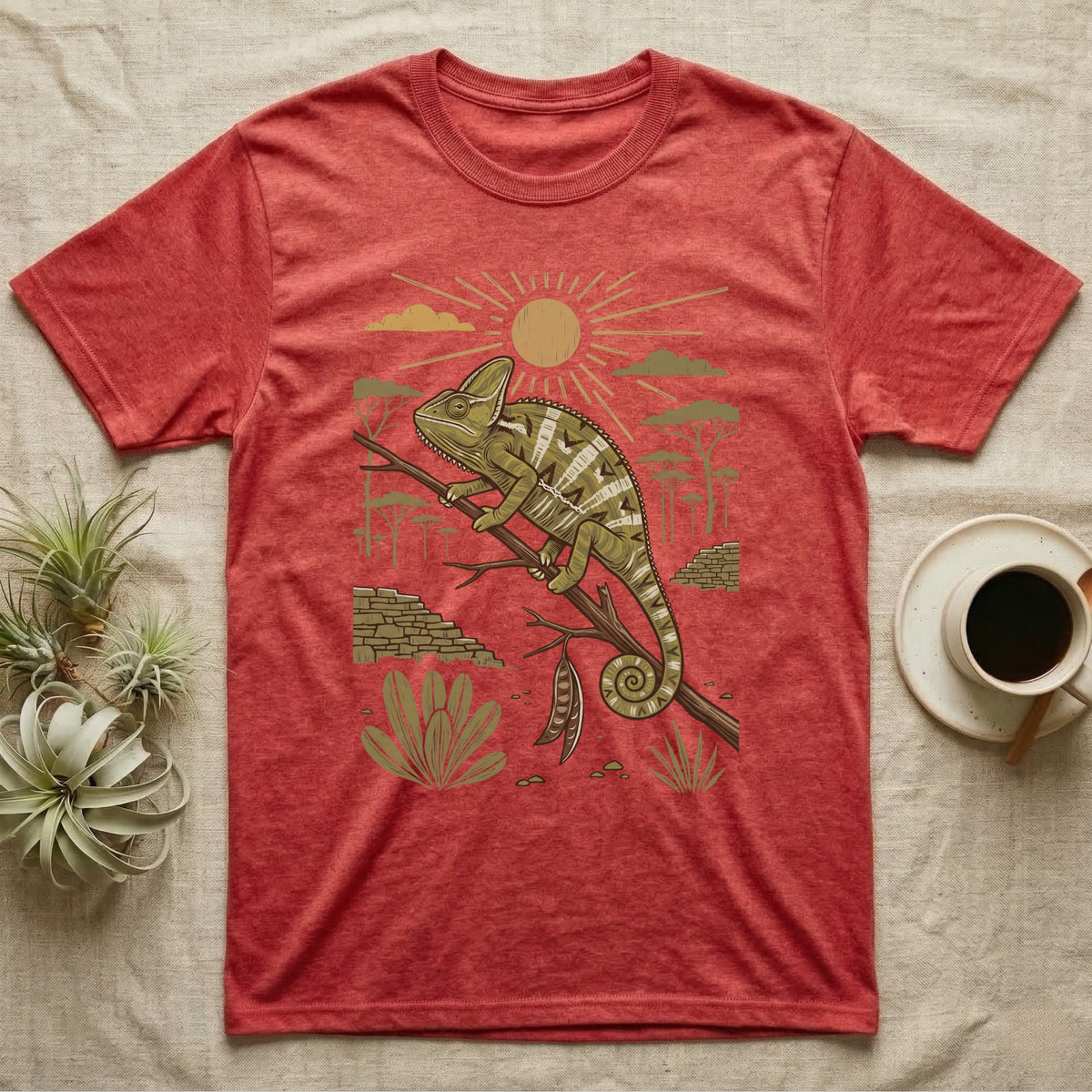 Veiled Chameleon Home Range T-Shirt in Heather Red — Woodcut-style illustration of a veiled chameleon gripping an acacia branch with terraced walls and umbrella trees behind, no on-shirt text.