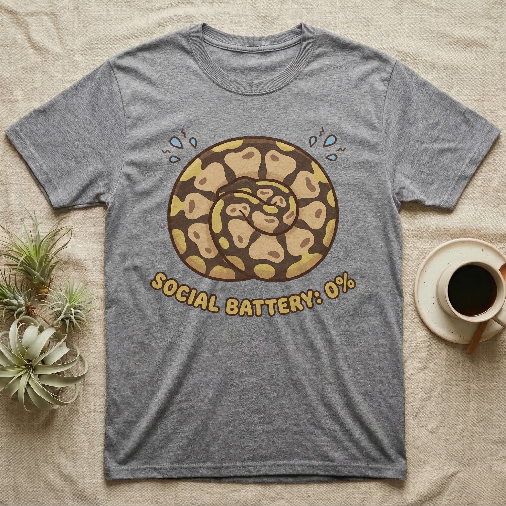 Grey t-shirt with coiled snake illustration and "SOCIAL BATTERY: 0%" text.