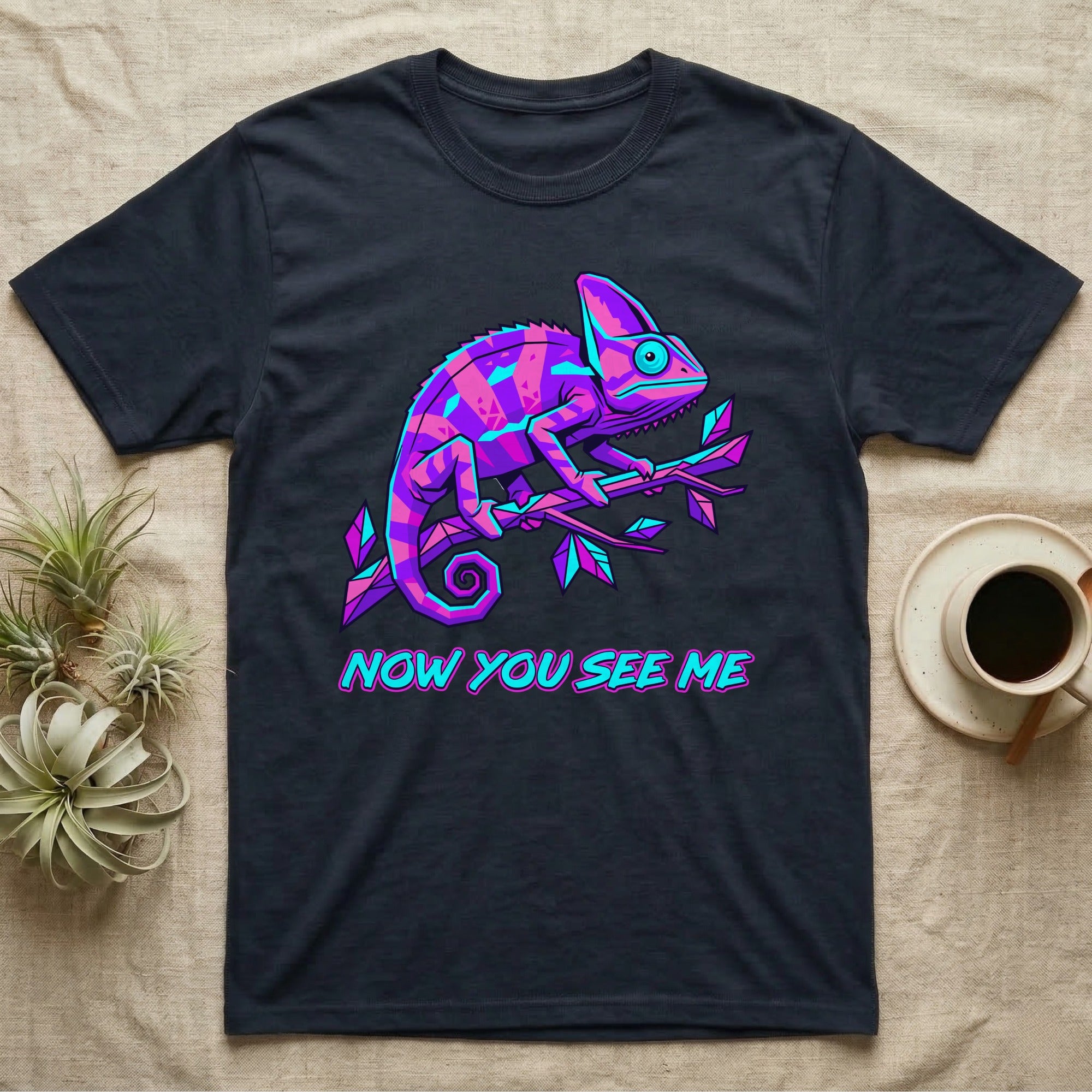Chameleon with text "NOW YOU SEE ME" on a dark t-shirt.