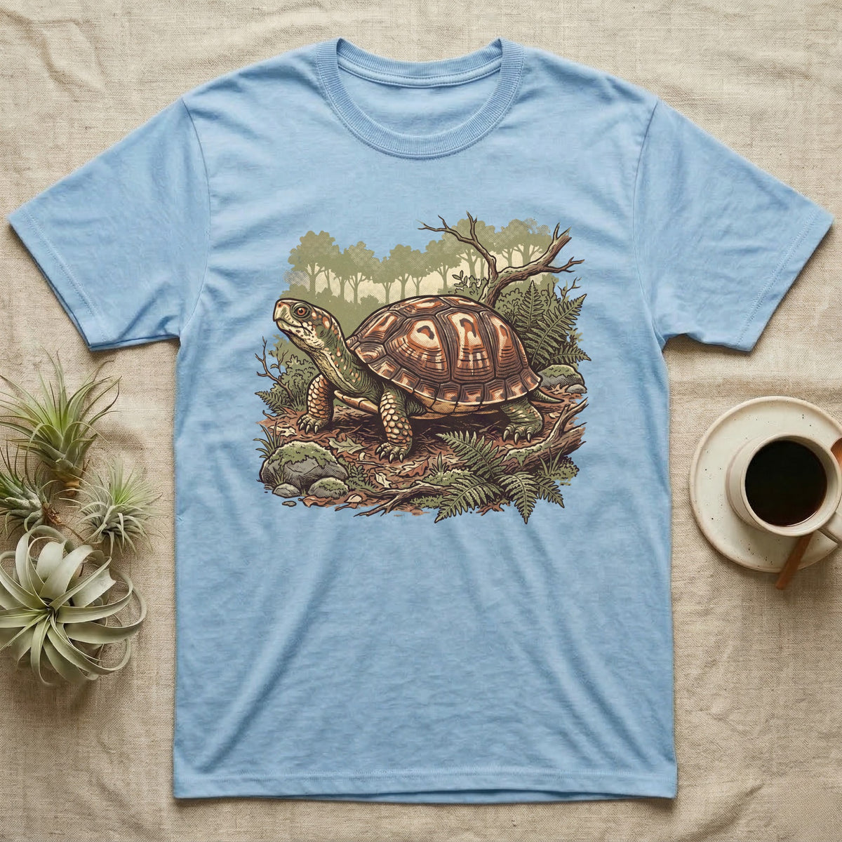 Wild Box Turtle T-Shirt in Light Blue — Retro conservation-poster illustration of a box turtle in a woodland habitat slice with ferns and leaf litter.