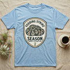 Ball Python Feeding Strike T-Shirt in Light Blue — Vintage-ink badge of a coiled ball python with carved type "Feeding Strike Season" and fine print "Months 3-7 Of Every Year."