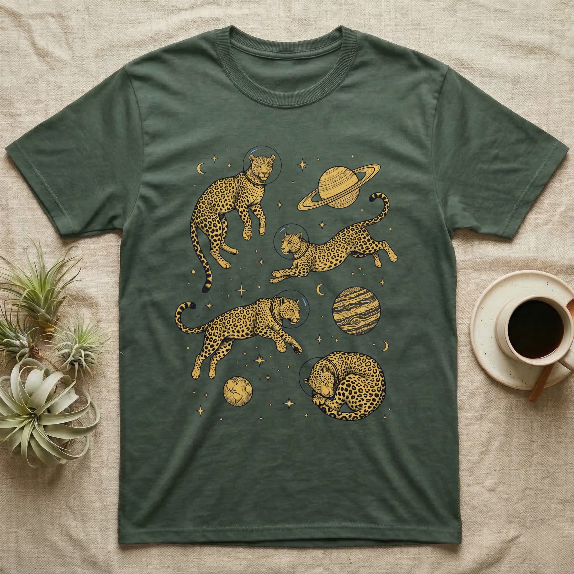 Green t-shirt with astronauts in space suits and planets.