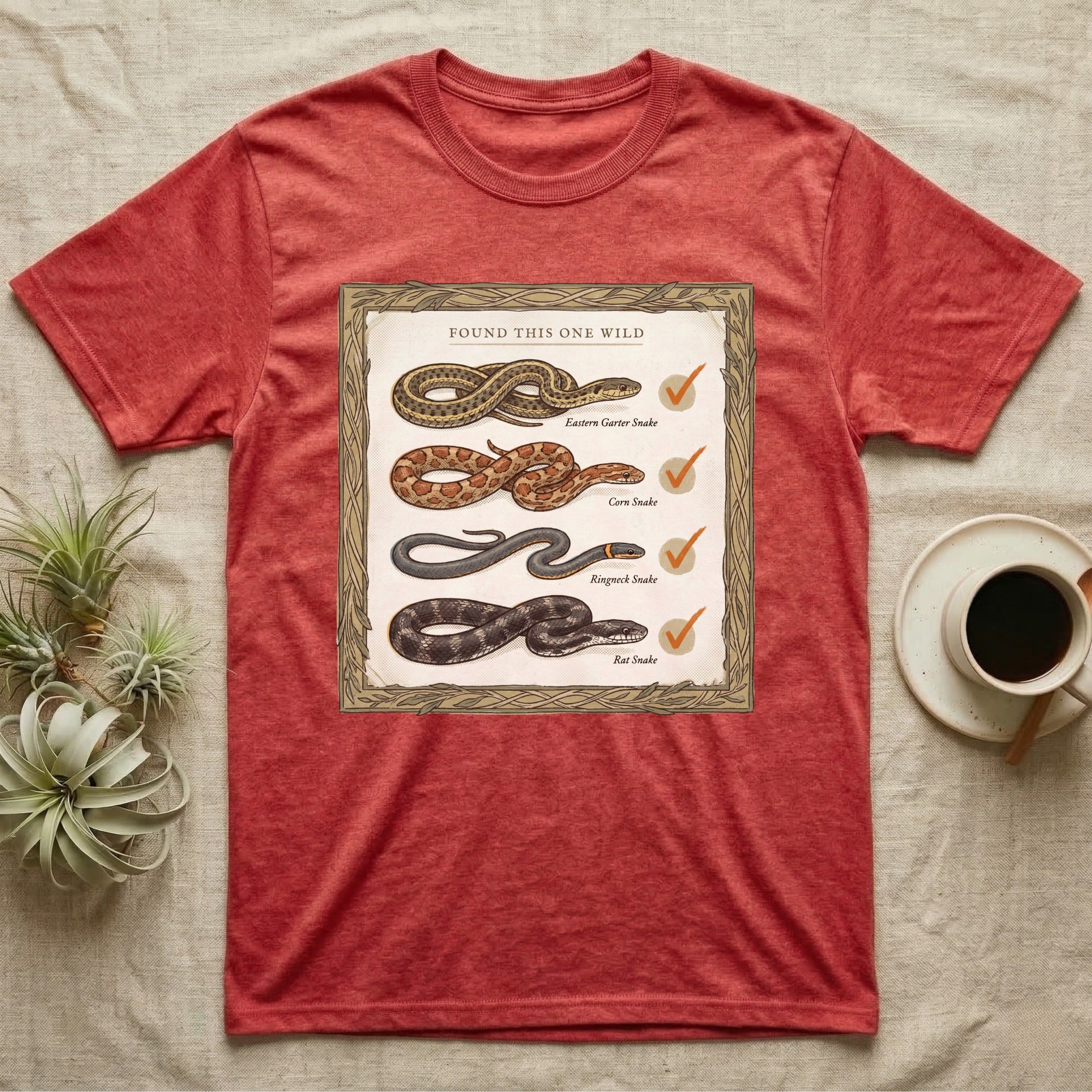 Native Snake Life List T-Shirt in Heather Red — Vintage field-guide life list of native snakes drawn as small specimens with tally checkmarks beside each.