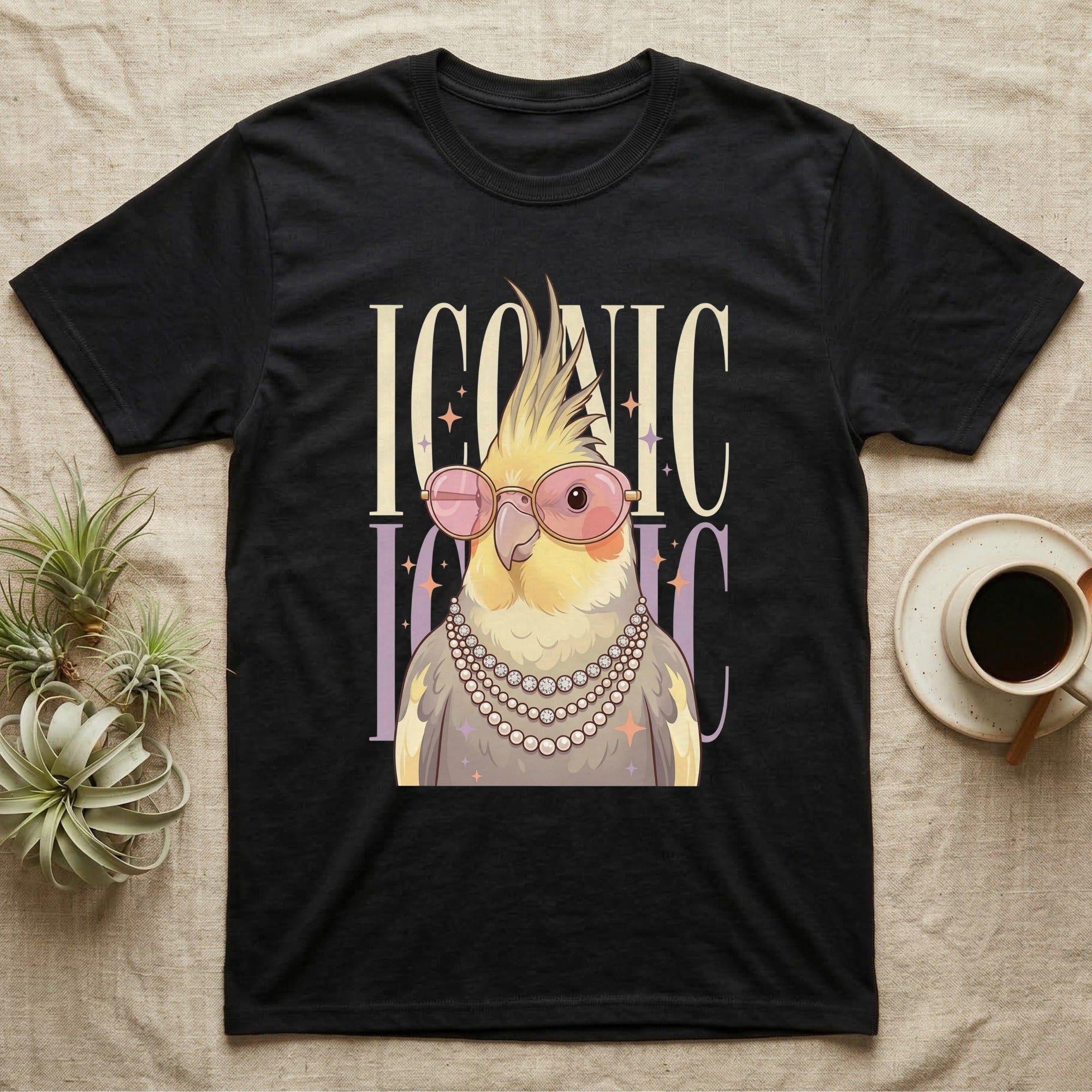 Black t-shirt with a cockatiel wearing pink sunglasses and pearls, with "ICONIC" text.