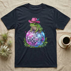 Frog wearing a pink cowboy hat sits on a disco ball.