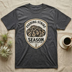 Ball Python Feeding Strike T-Shirt in Dark Heather — Vintage-ink badge of a coiled ball python with carved type "Feeding Strike Season" and fine print "Months 3-7 Of Every Year."