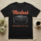 Snapping Turtle Modest T-Shirt in Black — White-line engraving of a huge snapping turtle in a stock tank under orange Modest script and a serif line