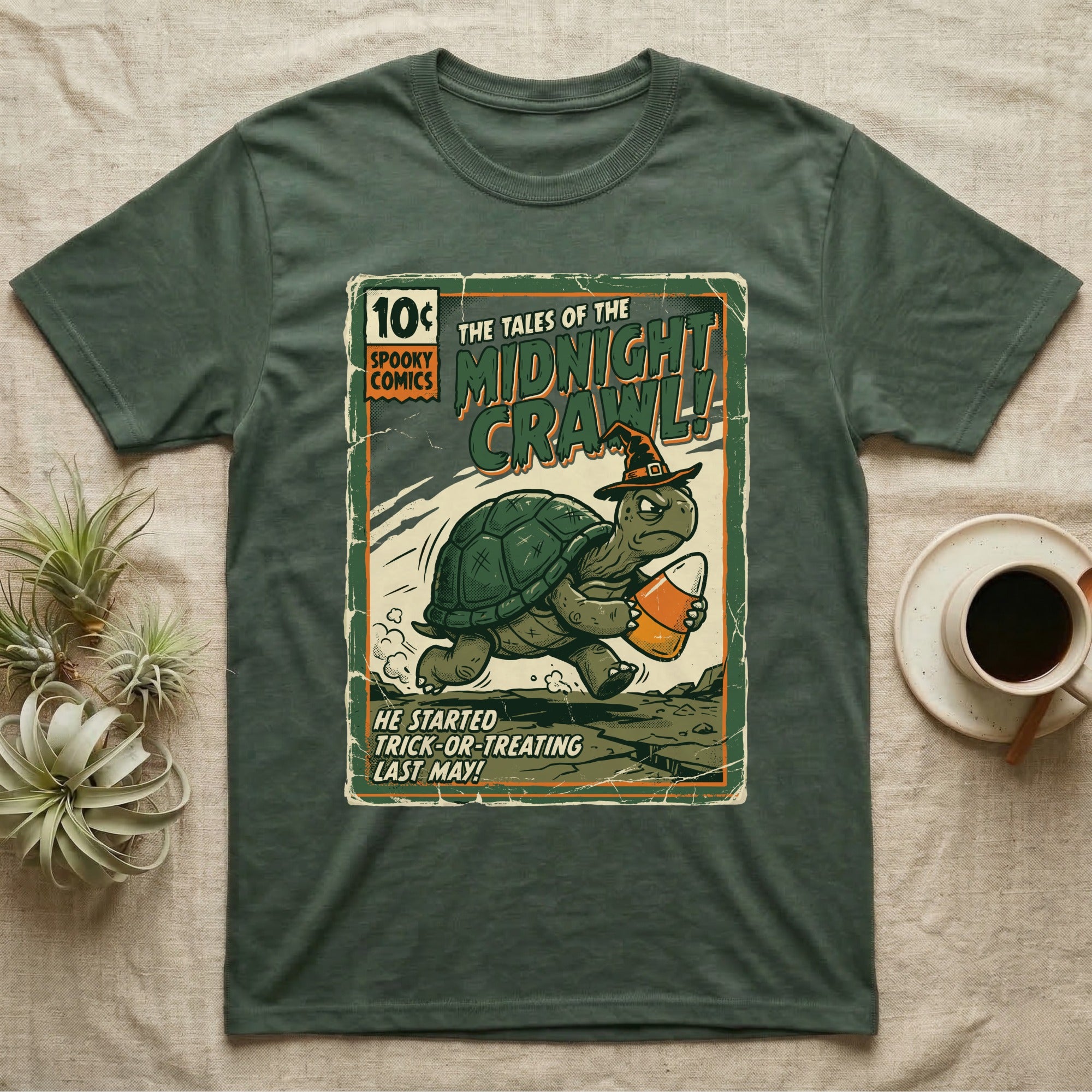 Tortoise Midnight Crawl Vintage T-Shirt in Military Green — Worn pulp comic cover of a witch-hatted tortoise dashing with a candy pail, "Tales of the Midnight Crawl."