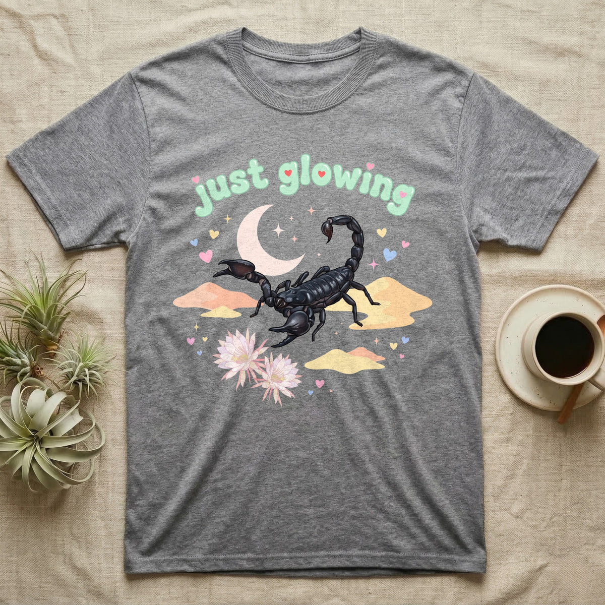 Emperor Scorpion Baby T-Shirt in Sport Grey — Black emperor scorpion, pincers raised, under a pastel moon and stars with puffy mint bubble text "just glowing".