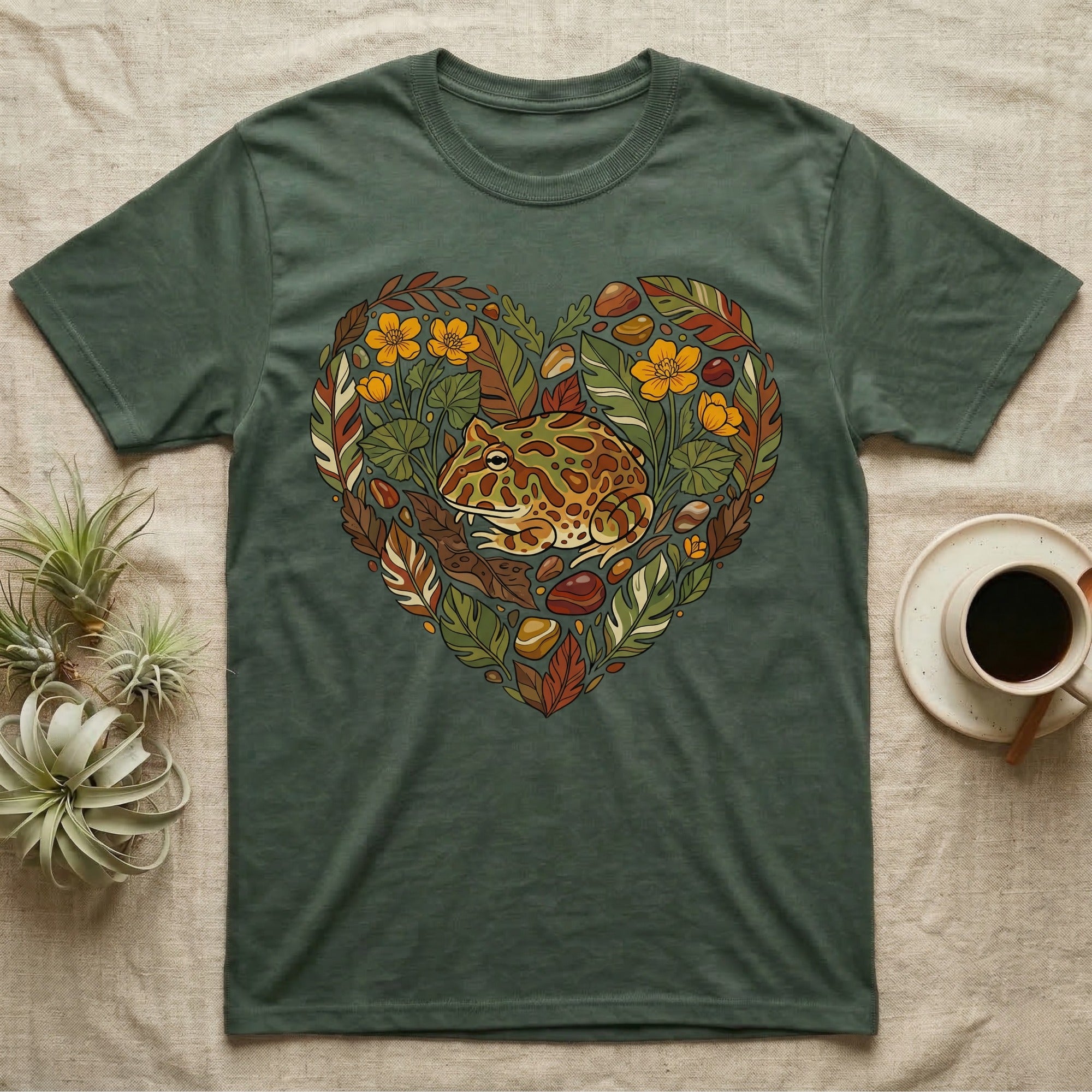 Green t-shirt with heart-shaped frog and leaf graphic.