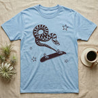 Western Hognose Kickflip T-Shirt in Light Blue — Distressed one-ink oxblood screenprint of a western hognose snake airborne, tail snapped straight into a skateboard caught upside down mid-kickflip.
