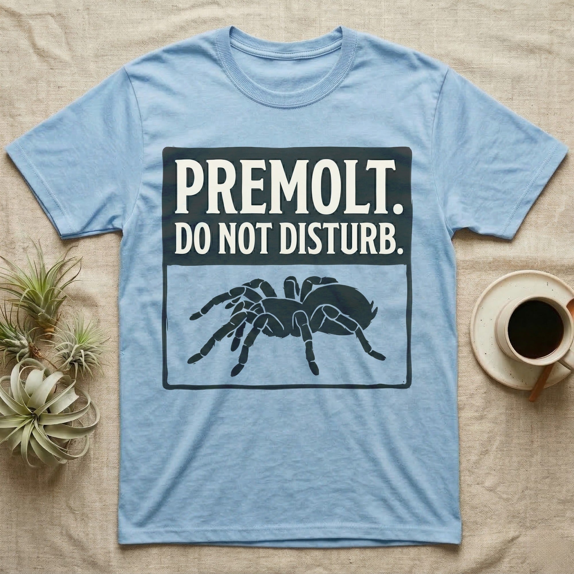 Tarantula Premolt Do Not Disturb T-Shirt in Light Blue — Vintage-ink sign with carved-serif type "Premolt. Do Not Disturb." above a tarantula curled in the cork-hide pose.