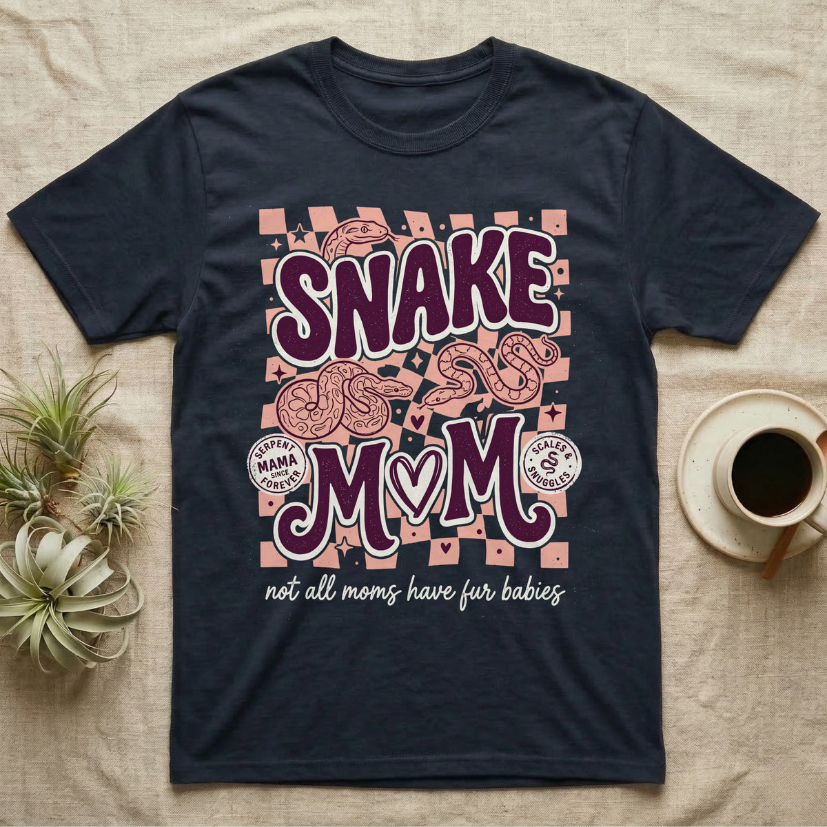 Dark t-shirt with "Snake Mom" and coiled snakes, "not all moms have fur babies".