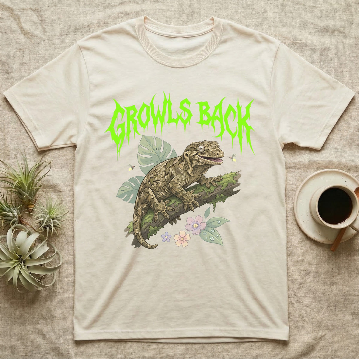 Leachianus Gecko Feral T-Shirt in Natural — Leachianus giant gecko on a mossy branch under jagged lime-green metal text GROWLS BACK with pastel leaves