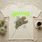 Leachianus Gecko Feral T-Shirt in Natural — Leachianus giant gecko on a mossy branch under jagged lime-green metal text GROWLS BACK with pastel leaves