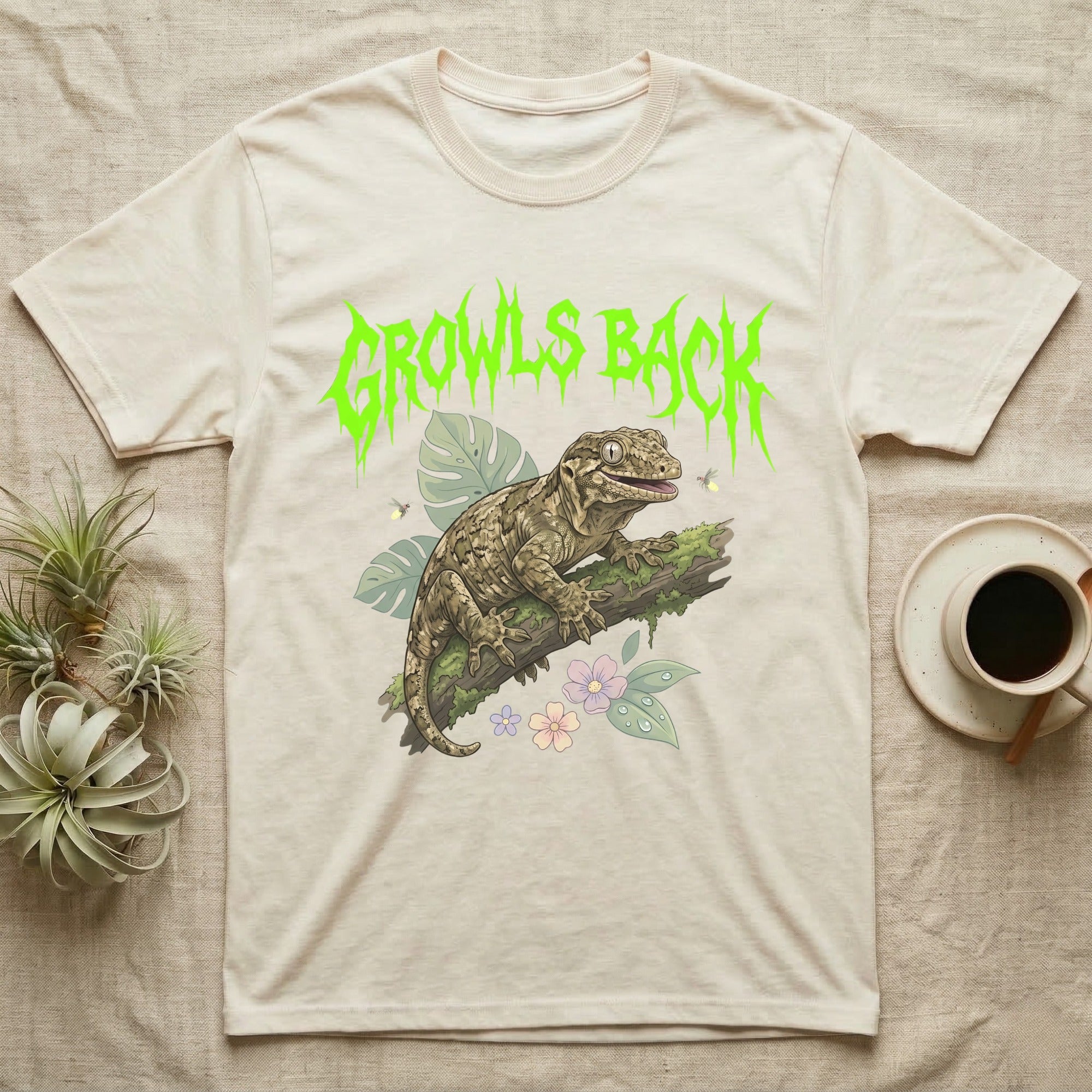Leachianus Gecko Feral T-Shirt in Natural — Leachianus giant gecko on a mossy branch under jagged lime-green metal text GROWLS BACK with pastel leaves