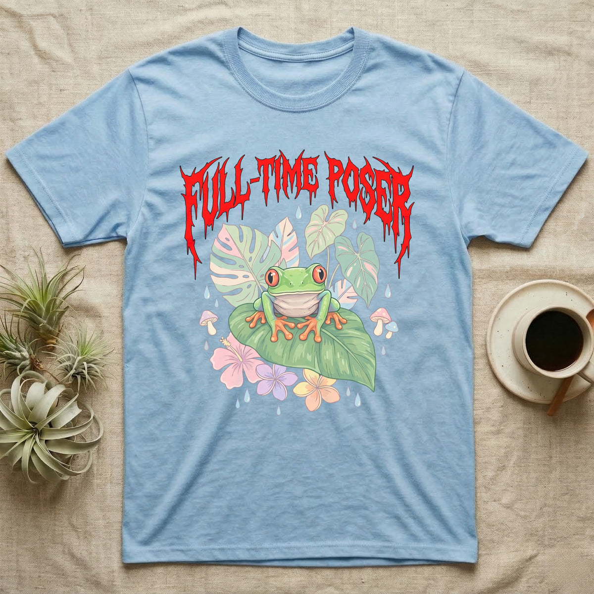 Red-Eyed Tree Frog Feral T-Shirt in Light Blue — Red-eyed tree frog on a leaf in a pastel jungle scene under a spiky red metal wordmark reading FULL-TIME POSER.