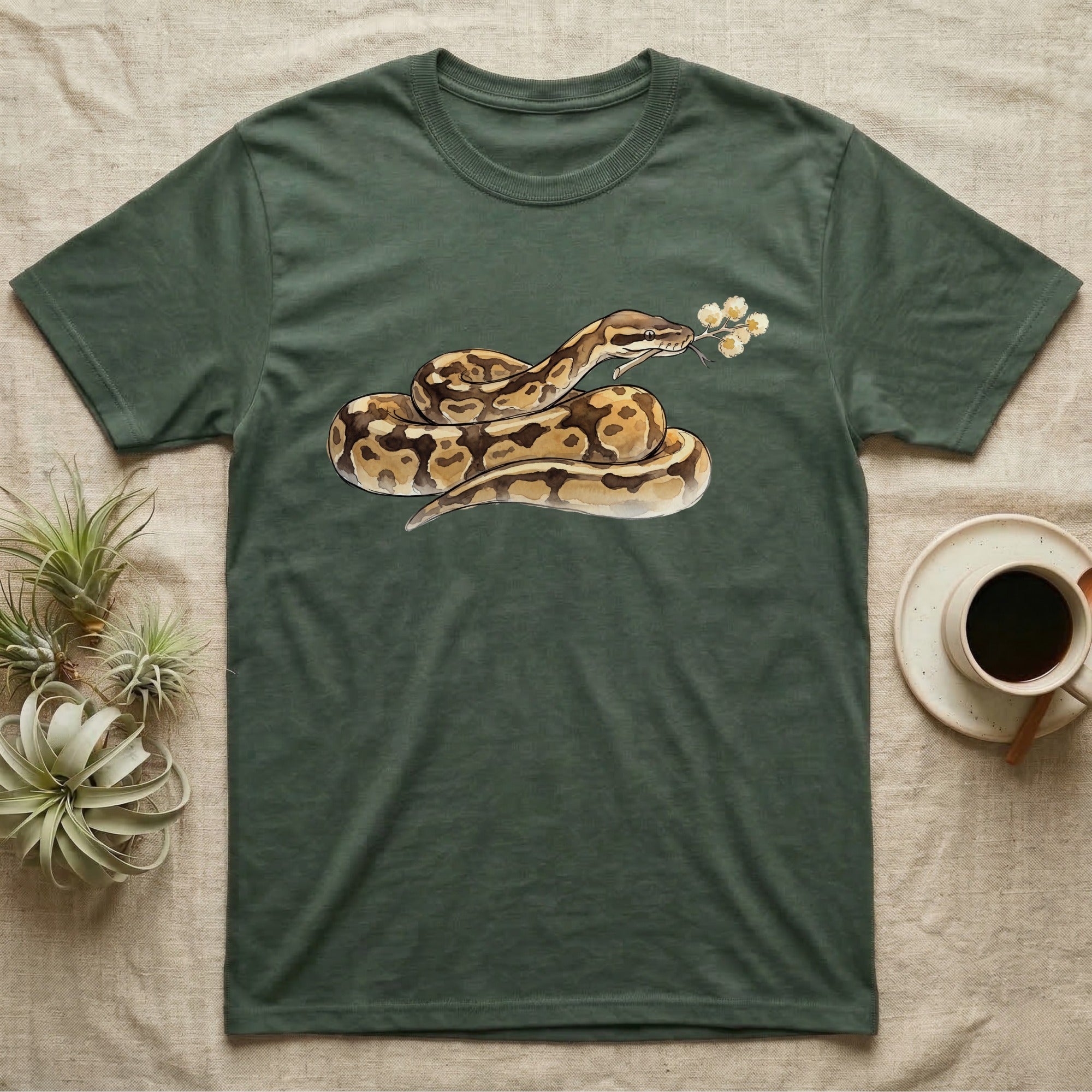 Ball Python Blossom T-Shirt in Military Green — Watercolor illustration of a tan-and-brown ball python holding an acacia blossom sprig, on a dark grey t-shirt.