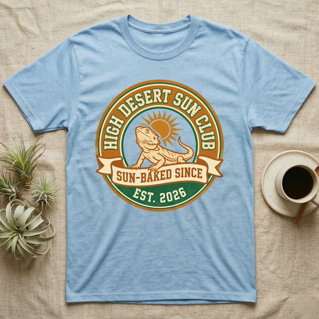 Light blue t-shirt with "High Desert Sun Club" logo featuring a bearded dragon.