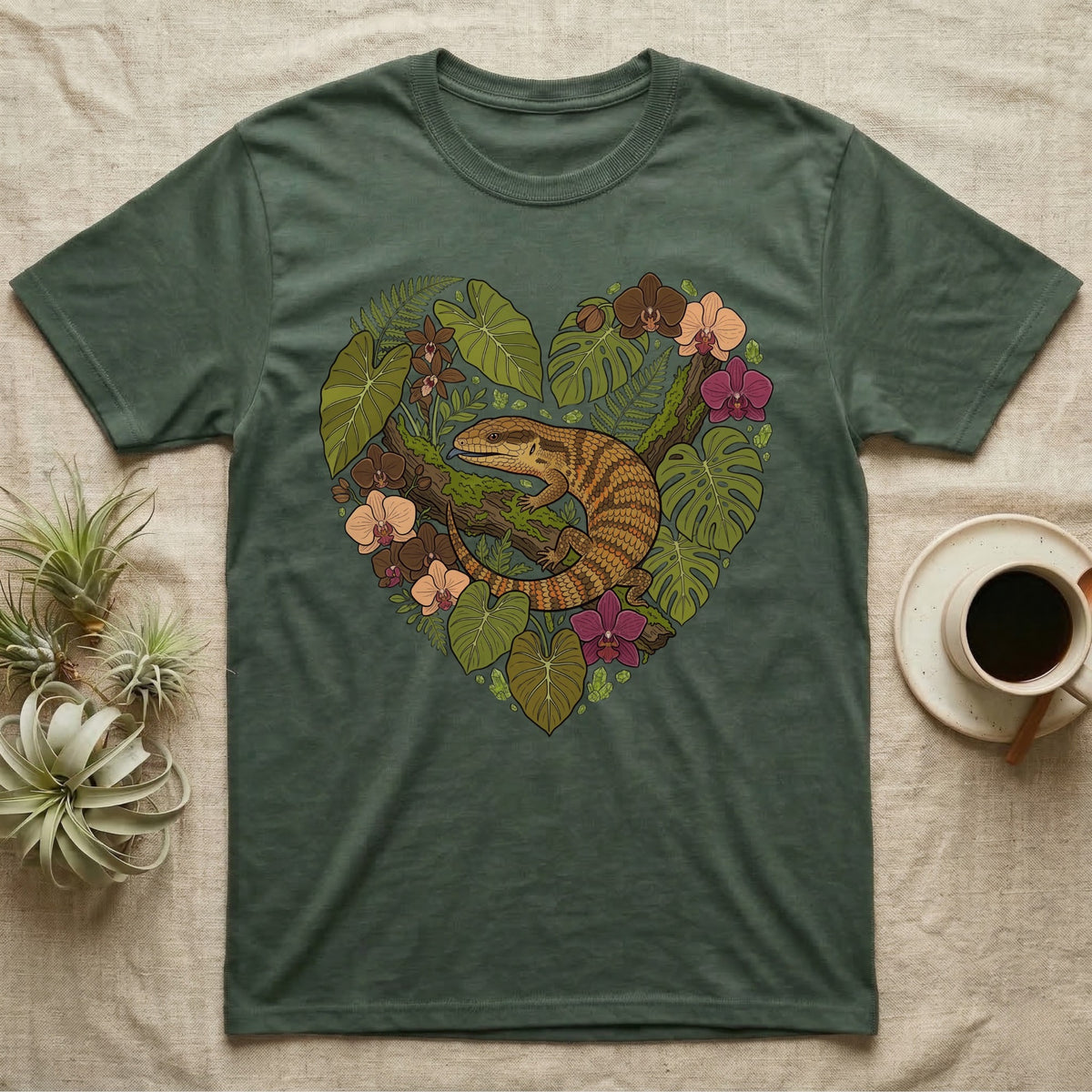 Green t-shirt with a heart-shaped floral design featuring a lizard.
