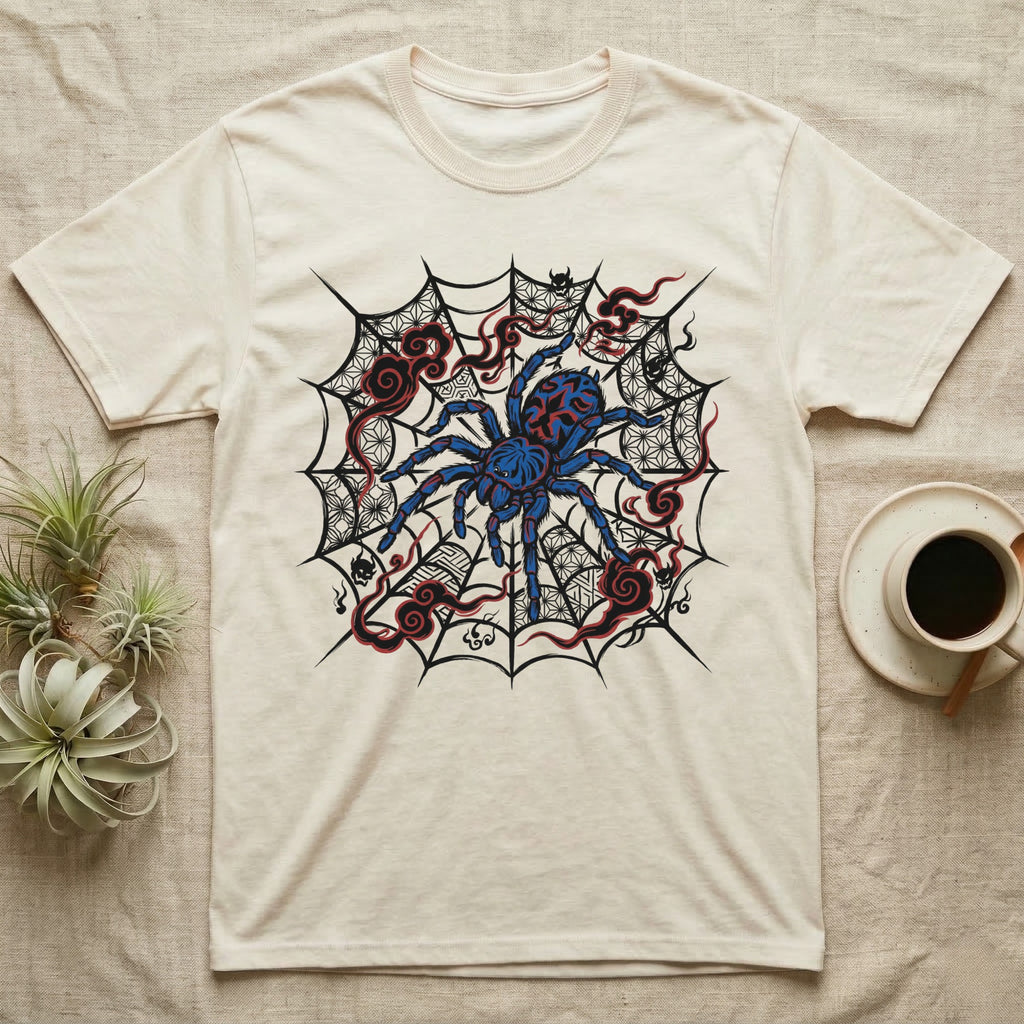 T-shirt with a blue tarantula on a spiderweb with red accents.