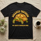 Black t-shirt with a Sulcata tortoise graphic and text "MY HEIR'S PROBLEM NOW."